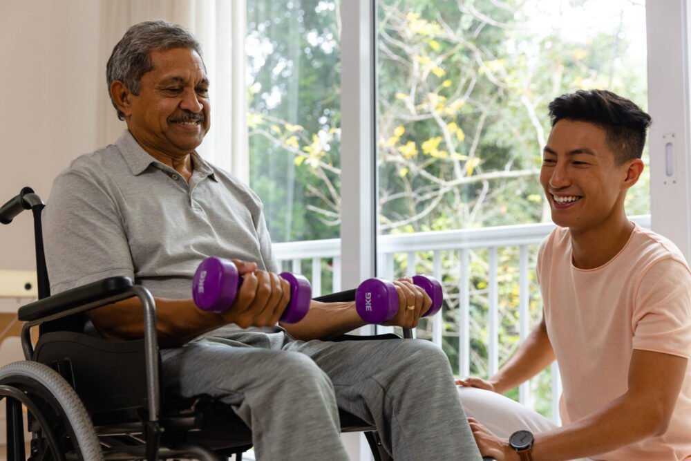 Home 11 Home | happy diverse male physiotherapist advising senior male patient wheelchair using dumbbells physiotherapy healthcare wellbeing senior lifestyle unaltered scaled e1752152691708